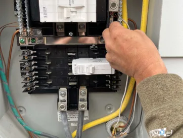Electrician checking the electrical lines in the power box