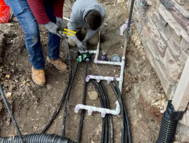 Two electricians working on electrical lines